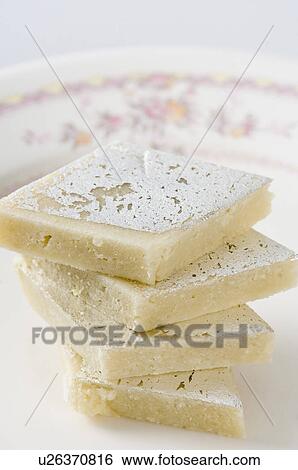 Stock Photograph - Close-up of a stack of Kaju Katli. Fotosearch