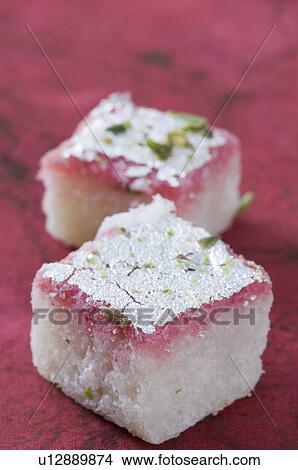 Picture - Close-up of Burfi garnished with Pistachio. Fotosearch