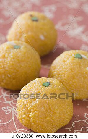 Stock Image - Close-up of four Ladoos. Fotosearch
