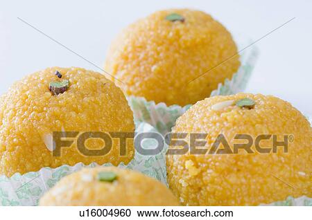 Stock Image - Close-up of four Ladoos. Fotosearch
