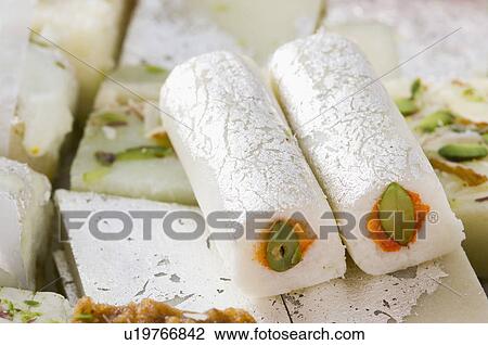 Stock Image - Close-up of Kaju roll with Kaju Katli. Fotosearch