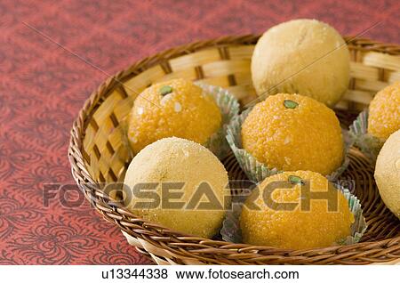 Close-up of Ladoos in a basket View Large Photo Image Stock Photo - Close-up of Ladoos in a basket. Fotosearch
