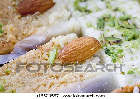 Close-up of milk cake and Burfi garnished with Almonds and Pistachio View Large Photo Image Stock Photo - Close-up of milk cake and Burfi garnished with Almonds and Pistachio. Fotosearch