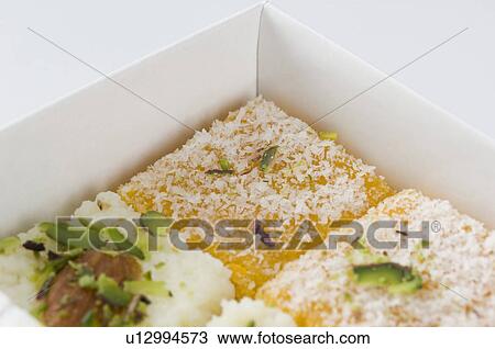 Stock Image - Close-up of Moong Daal Burfi in a box. Fotosearch