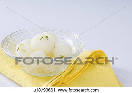 Stock Image - Close-up of Rasgullas in a bowl. Fotosearch