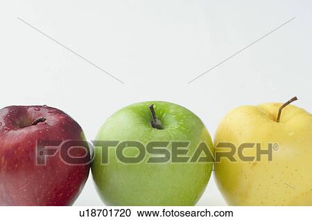 Stock Image - Close-up of three apples in a row. Fotosearch
