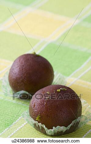 Stock Photo - Close-up of two Gulab Jamuns. Fotosearch