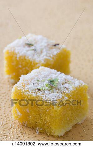 Stock Image - Close-up of two Moong Daal Burfis. Fotosearch