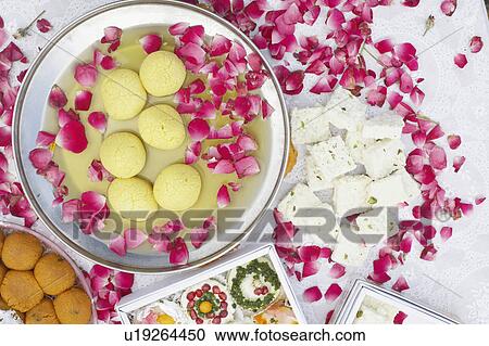 High angle view of a dish of Indian sweets with flower petals around it View Large Photo Image Stock Image - High angle view of a dish of Indian sweets with flower petals around it. Fotosearch