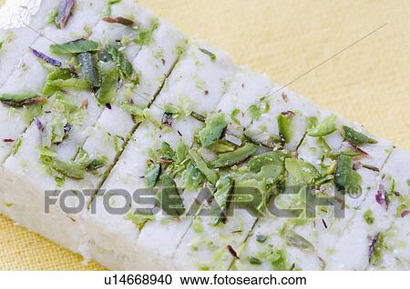 Stock Image - High angle view of Burfi garnished with Pistachios. Fotosearch