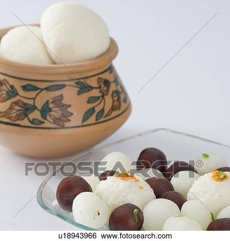 Stock Photograph - Rasgullas and Gulab Jamuns in a bowl. Fotosearch