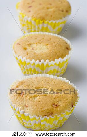 Stock Image - Three cupcakes in a row. Fotosearch