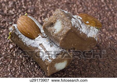 Stock Photo - Close-up of a chocolate roll garnished with Almonds. Fotosearch