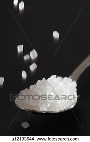 Picture - Close-up of a spoon full of sugar. Fotosearch