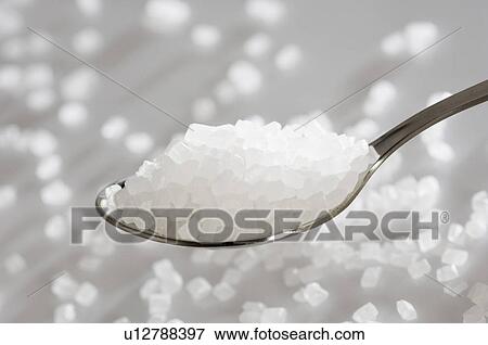 Stock Photo - Close-up of a spoon full of sugar. Fotosearch