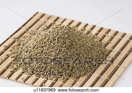 Stock Photo - Close-up of Cumin seeds on a place mat. Fotosearch