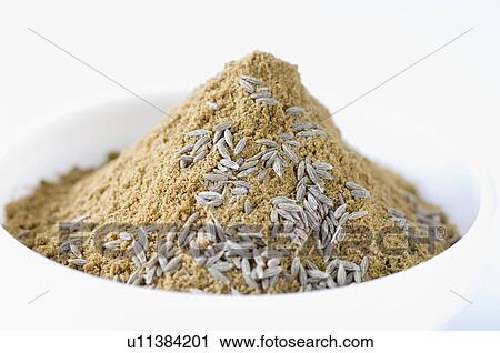Stock Image - Close-up of Cumin seeds with Coriander powder in a bowl. Fotosearch