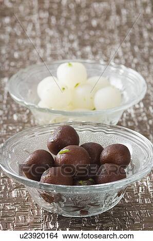 Picture - Close-up of Gulab Jamuns and Rasgullas in two bowls. Fotosearch