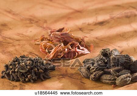 Stock Photography - High angle view of Black Cardamoms and cloves with dried Mace blades. Fotosearch