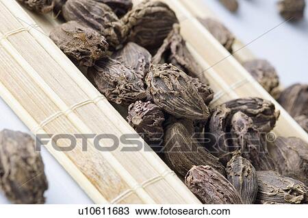 Stock Image - High angle view of Black Cardamoms on a place mat. Fotosearch