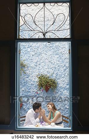Couple holding hands in restaurant View Large Photo Image Stock Image - Couple holding hands in restaurant. Fotosearch