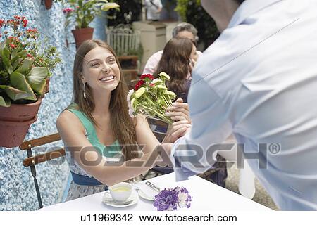 Man giving bunch of flowers to woman View Large Photo Image Stock Image - Man giving bunch of flowers to woman. Fotosearch