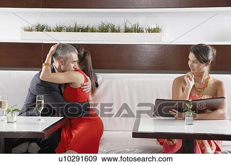 Man hugging girlfriend and flirting with other woman View Large Photo Image Stock Photo - Man hugging girlfriend and flirting with other woman. Fotosearch