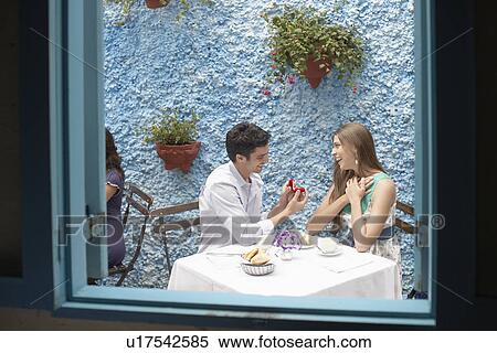 Man proposing woman in restaurant View Large Photo Image Stock Photography - Man proposing woman in restaurant. Fotosearch
