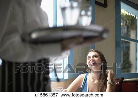 Stock Photo - Waiter near female customer. Fotosearch