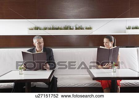 Woman and man with menus flirting View Large Photo Image Stock Image - Woman and man with menus flirting. Fotosearch