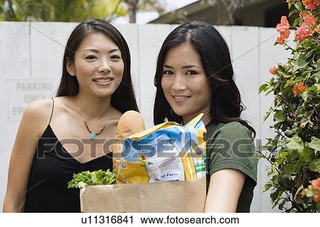 Stock Image - Portrait of young women smiling. Fotosearch