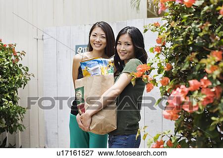 View of young women together smiling View Large Photo Image Stock Photo - View of young women together smiling. Fotosearch