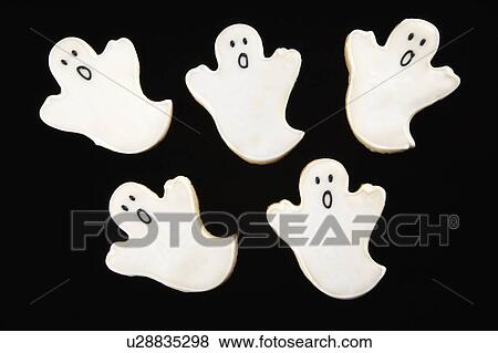 Stock Photo - Five sugar cookies in shape of ghosts with decorative icing.. Fotosearch