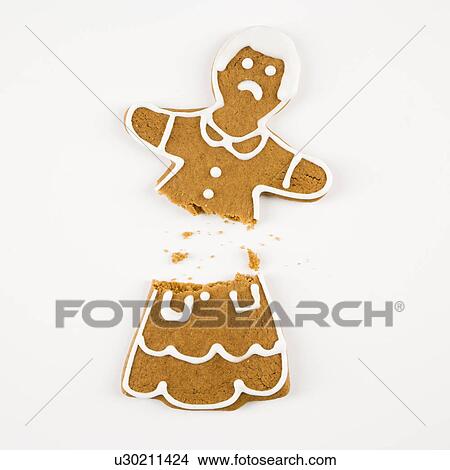 Frowning female gingerbread cookie broken in half. View Large Photo Image Picture - Frowning female gingerbread cookie broken in half.. Fotosearch