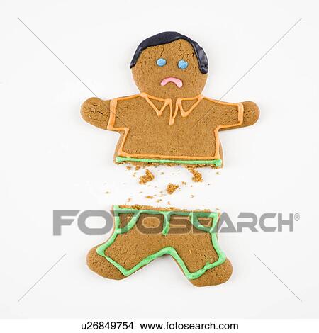 Frowning male gingerbread cookie broken in half. View Large Photo Image Picture - Frowning male gingerbread cookie broken in half.. Fotosearch