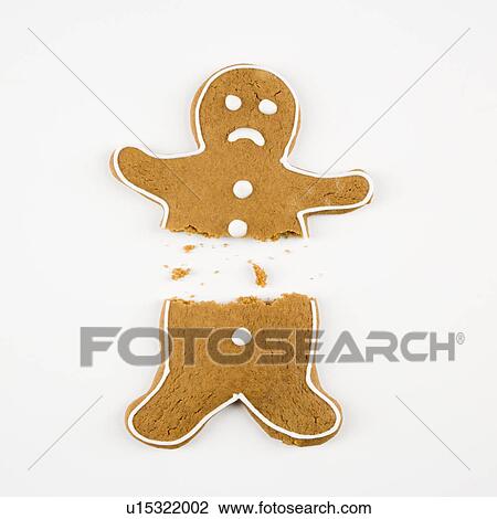 Stock Image - Frowning male gingerbread cookie broken in half.. Fotosearch