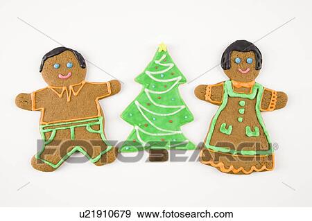 Stock Photo - Sugar cookie Christmas tree between gingerbread male and female.. Fotosearch