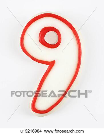 Picture - Sugar cookie in the shape of a number nine outlined in red icing.. Fotosearch