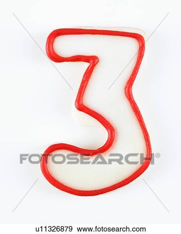 Stock Photo - Sugar cookie in the shape of a number three outlined in red icing.. Fotosearch