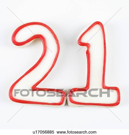Stock Photography - Sugar cookies in the shape of the number twenty one outlined in red icing.. Fotosearch