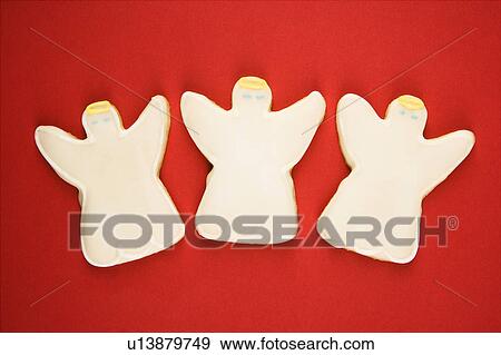 Stock Photo - Three angel sugar cookies with decorative icing.. Fotosearch