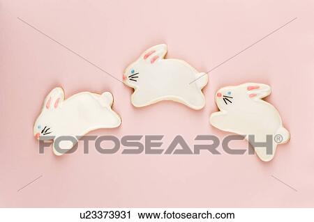 Stock Image - Three bunny shaped sugar cookies with decorative icing.. Fotosearch