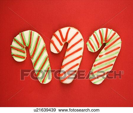 Stock Photo - Three candy cane sugar cookies with decorative icing.. Fotosearch