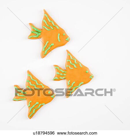 Stock Photograph - Three fish shaped sugar cookies with decorative icing.. Fotosearch