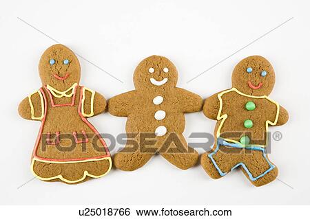 Stock Photograph - Three male and female gingerbread cookies holding hands.. Fotosearch