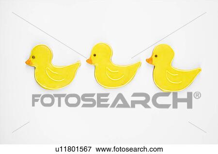Stock Photo - Three sugar cookies in shape of ducks with decorative icing.. Fotosearch