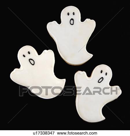 Stock Photo - Three sugar cookies in shape of ghosts with decorative icing.. Fotosearch