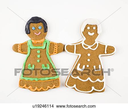 Two female gingerbread cookies holding hands. View Large Photo Image Picture - Two female gingerbread cookies holding hands.. Fotosearch