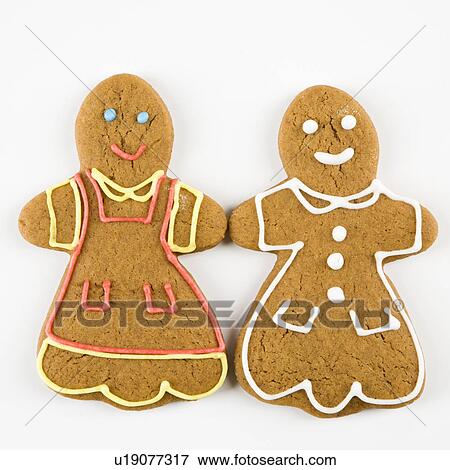 Stock Photo - Two female gingerbread cookies holding hands.. Fotosearch
