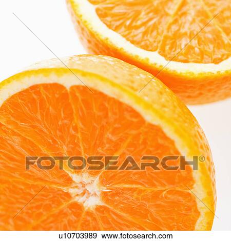 Stock Photo - Close up of halved orange against white background.. Fotosearch